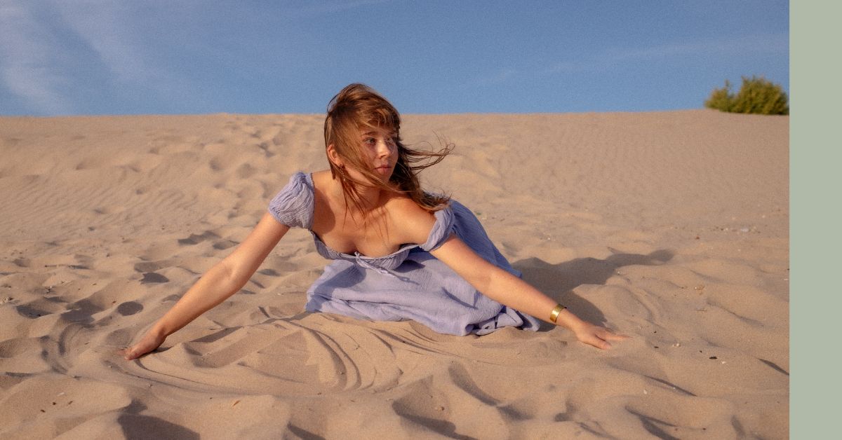 Sondara holistic home - girl sitting in sand dunes